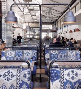 Cafe with blue/vintage bus seats as the dining area