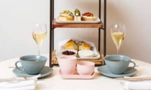 High tea setting with chamapagne and cakes