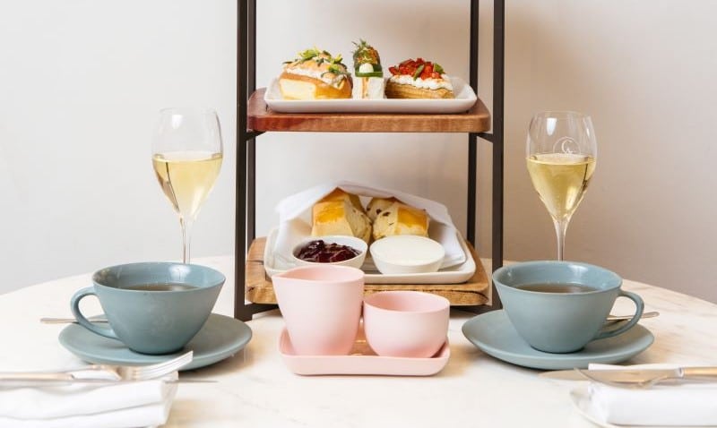 High tea setting with chamapagne and cakes