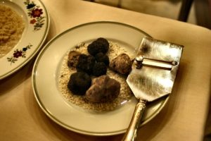 Assortment of truffles in a bowl next to shaver