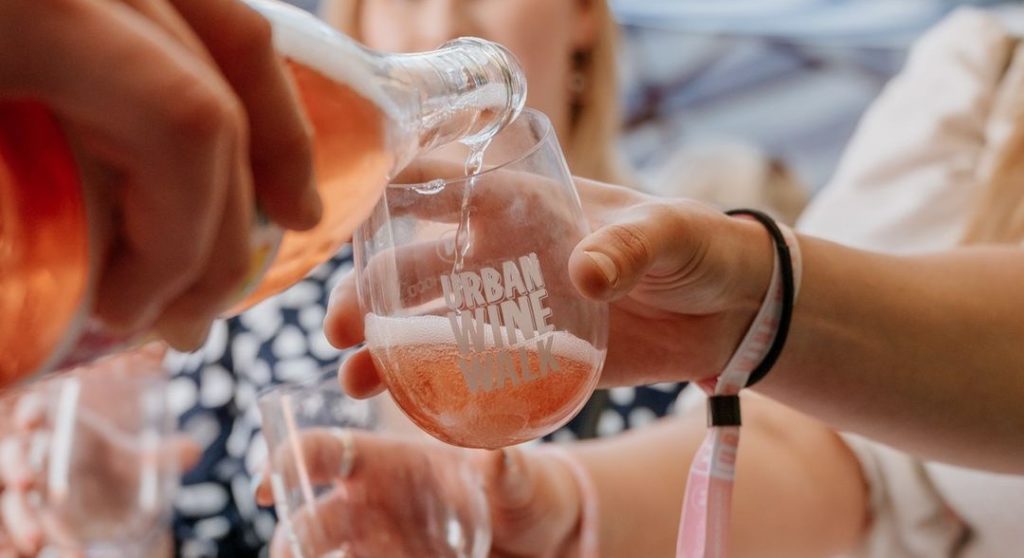 Close-up on bottle of rose being poured into a glass