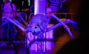Ginat, purple, spider sculpture in the dark