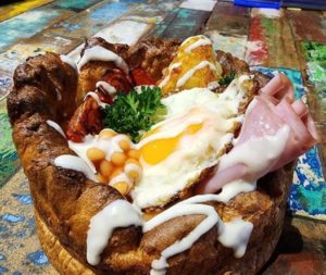 Giant yorkshire pudding stuffed with big English breakfast )bacon, beans, eggs, sausages, hashbrown)