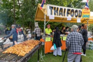Outdoor marketplace, Thai food vendor cooking up a storm in the parkalnds